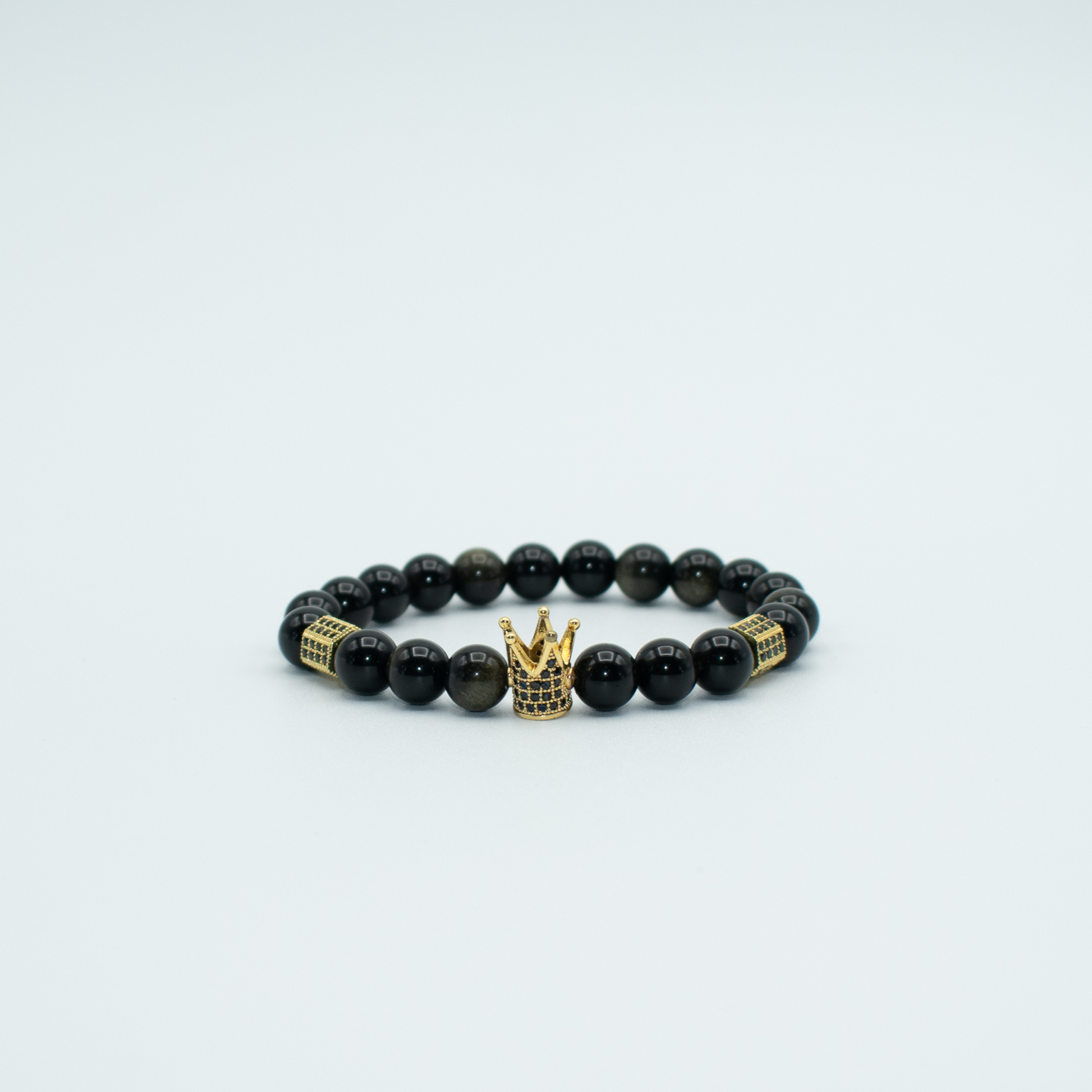   PRODUCT DETAILS  8mm Golden Obsidian Beads Gold Pave Rhinestone Crown and Accents Stretch  7.5 Inches 0.7oz Handmade in USA We use premium durable materials and stones in our jewelry. All pieces may vary slightly in color, shape, and size. Please measure your wrist before you make your purchase for an accurate fit.&nbsp;Please leave a message if you need a different size. You will receive a free: Storage box or bag and cleaning cloth with your order.