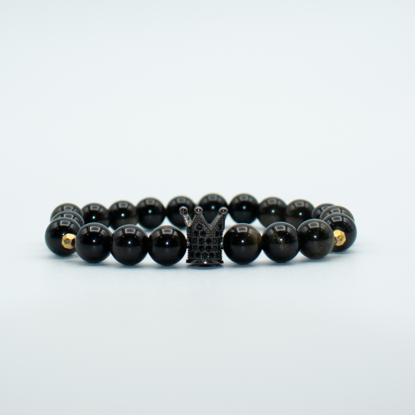 PRODUCT DETAILS  8mm Golden Obsidian Beads Black Crown Charm Stretch  7.5 Inches 0.9oz Handmade in USA We use premium durable materials and stones in our jewelry. All pieces may vary slightly in color, shape, and size. Please measure your wrist before you make your purchase for an accurate fit.&nbsp;Please leave a message if you need a different size. You will receive a free: Storage box or bag and cleaning cloth with your order.